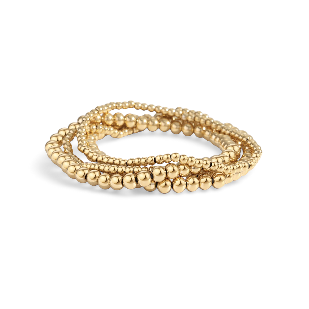 Two gold-colored beaded bracelets with a gold-filled design, displayed in a stacked arrangement.