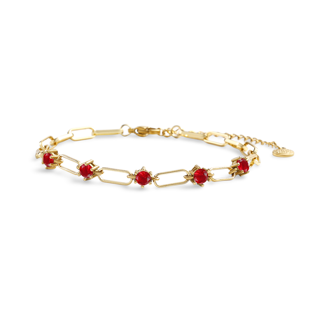 Gold bracelet with red stones on a white background