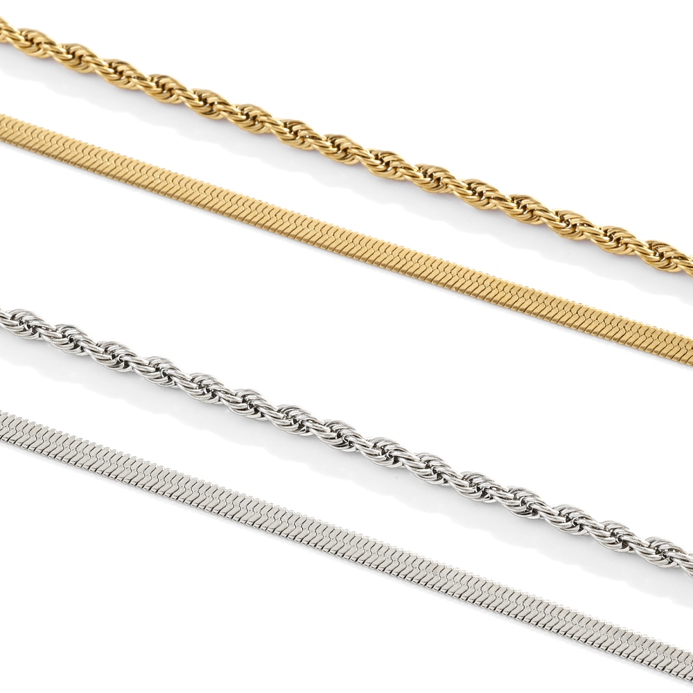Three gold and silver chains on a white background