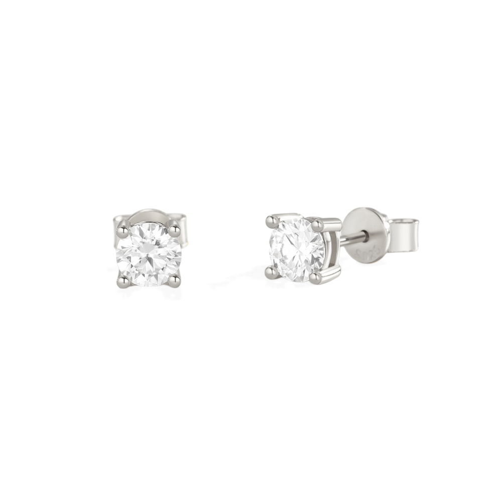 A pair of classic diamond solitaire earrings set in gold.