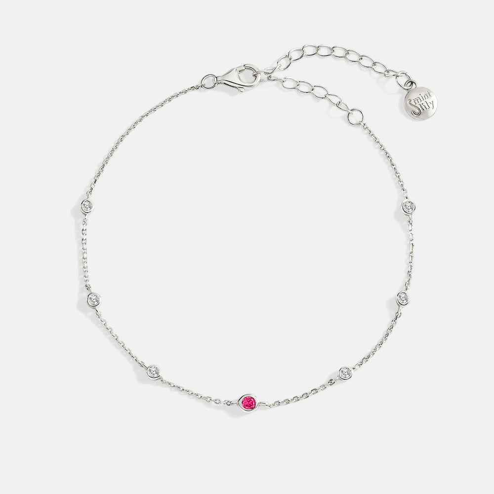 Silver bracelet with a pink gemstone on a white background