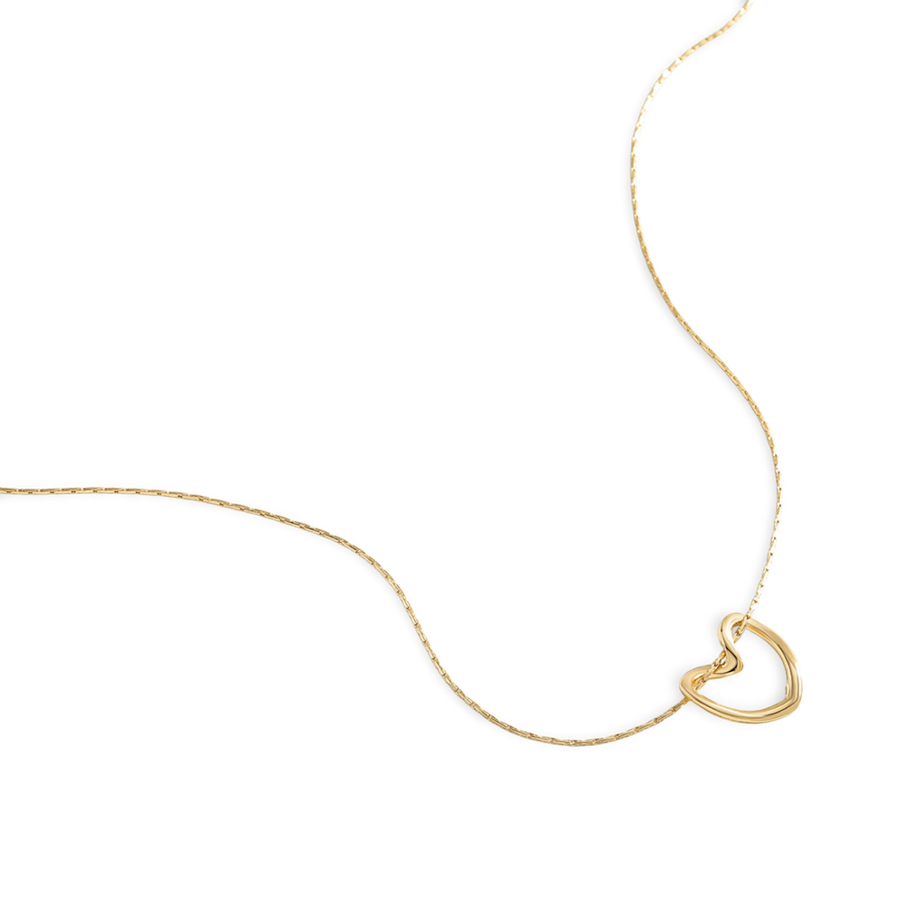 Gold necklace with a heart-shaped pendant on a white background