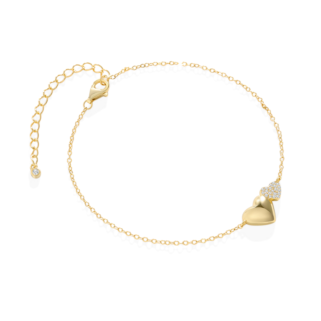 Gold bracelet with a heart-shaped clasp on a light gray background