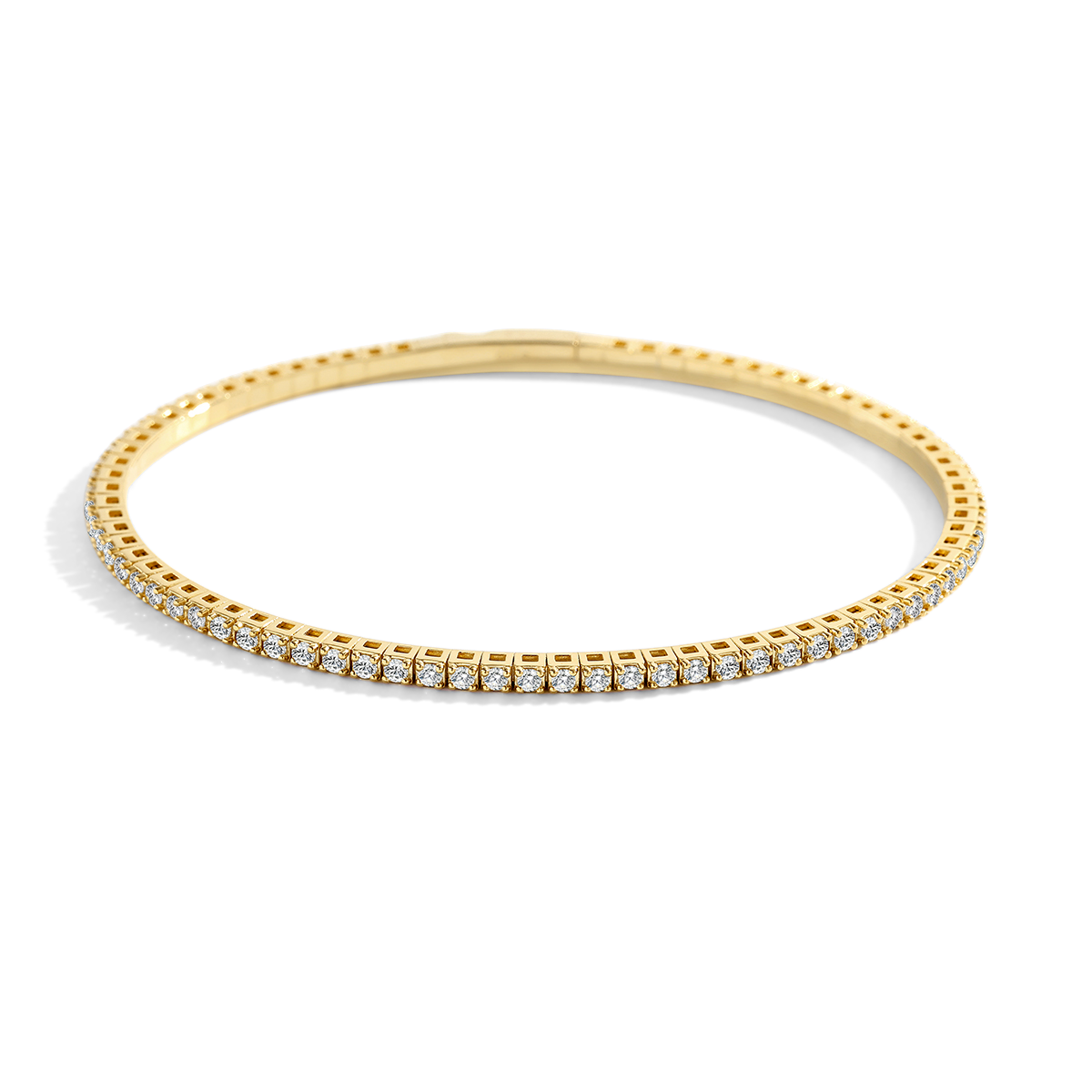Gold bracelet with cubic zirconia gemstones on a light gray background