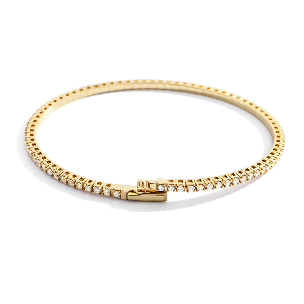 Gold bracelet with diamonds on a light gray background