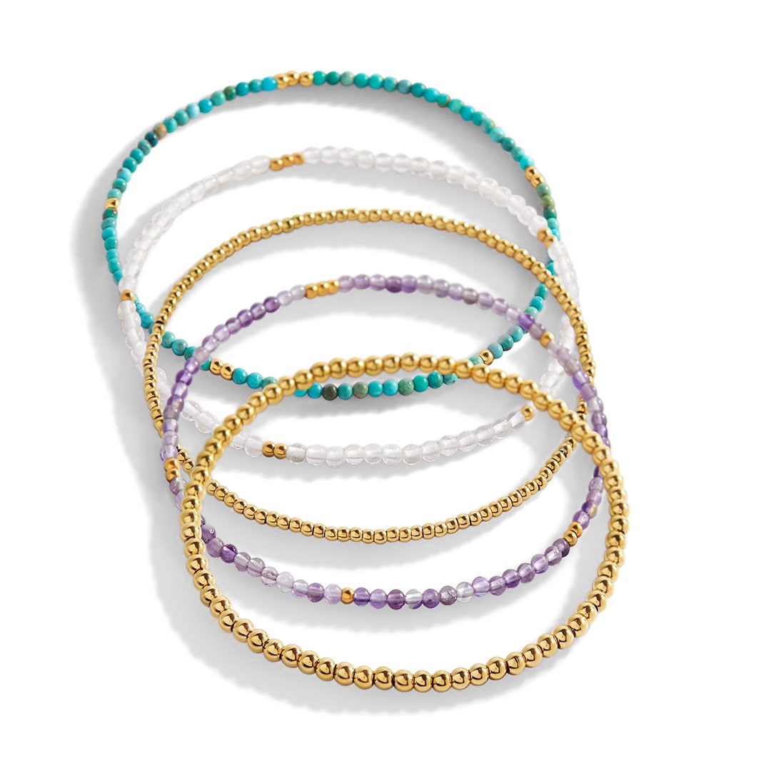 Set of multicolored beaded bracelets on a white background