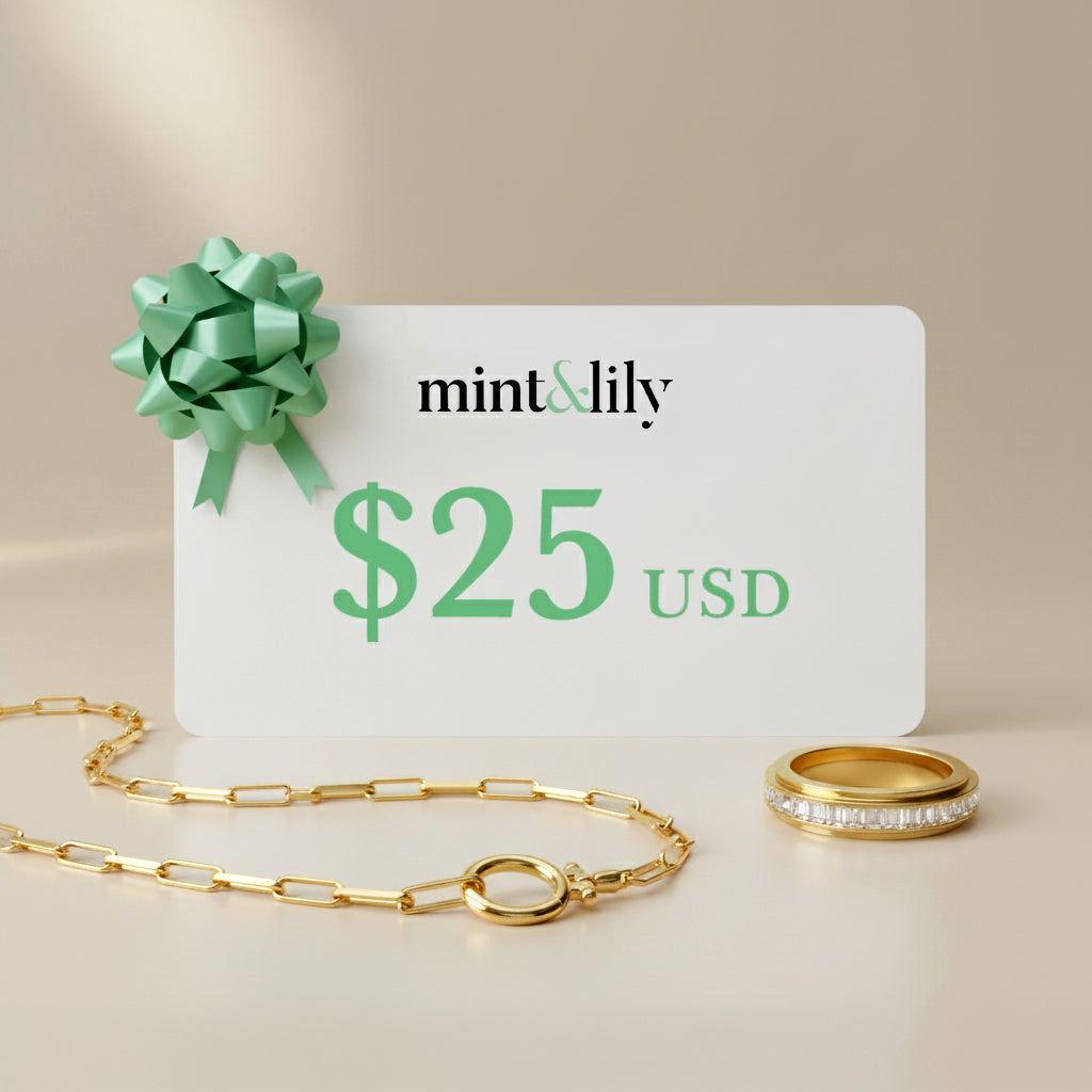 Mint & Lily gift card with a green bow and $25 USD value, accompanied by a gold necklace and ring on a beige background.