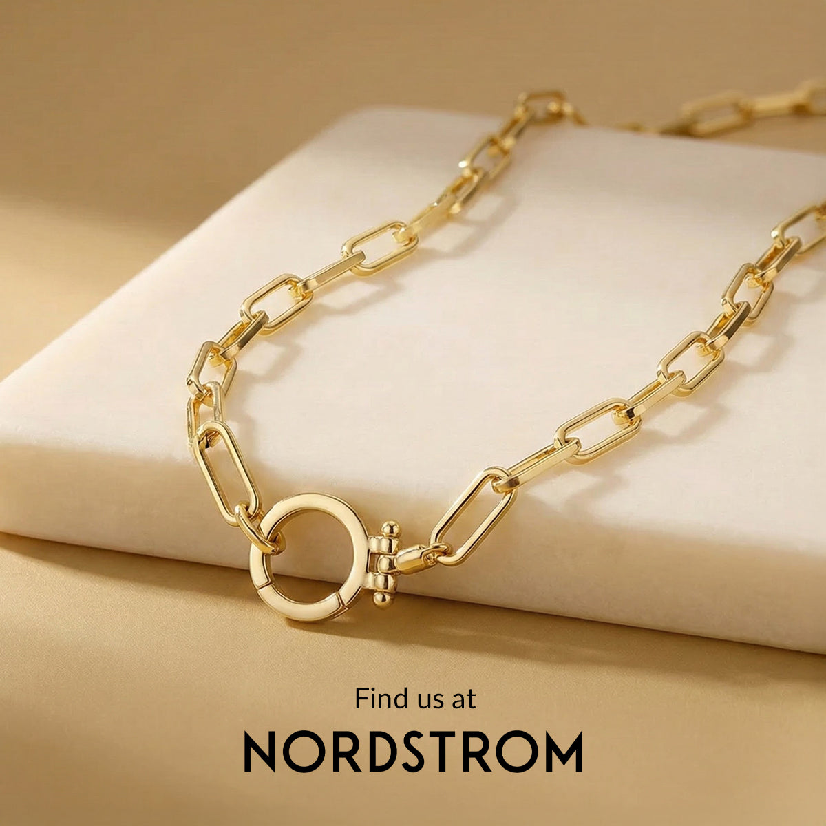 Gold chain necklace on a beige surface with Nordstrom branding.