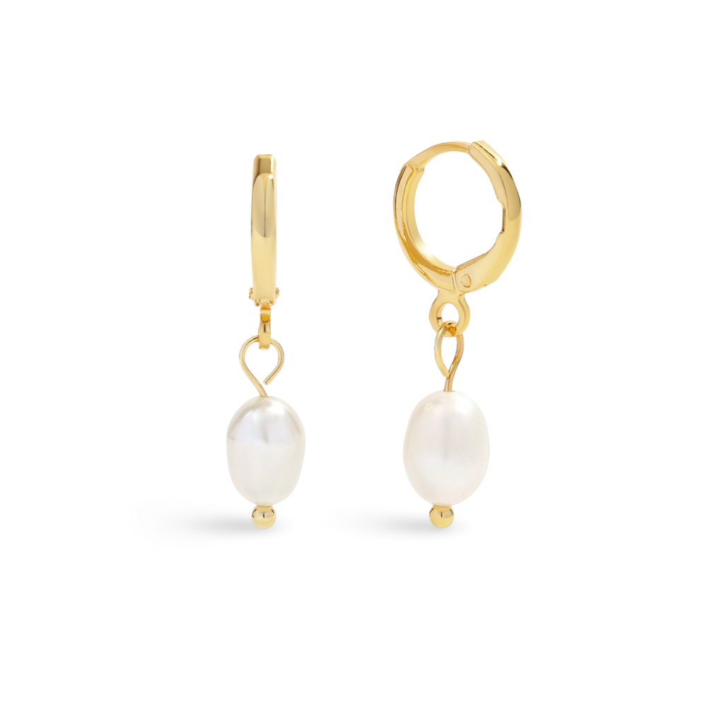 Gold hoop earrings with pearl drops on a light gray background