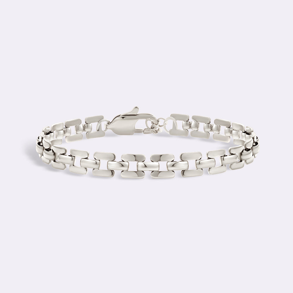 Silver chain bracelet on a light gray background