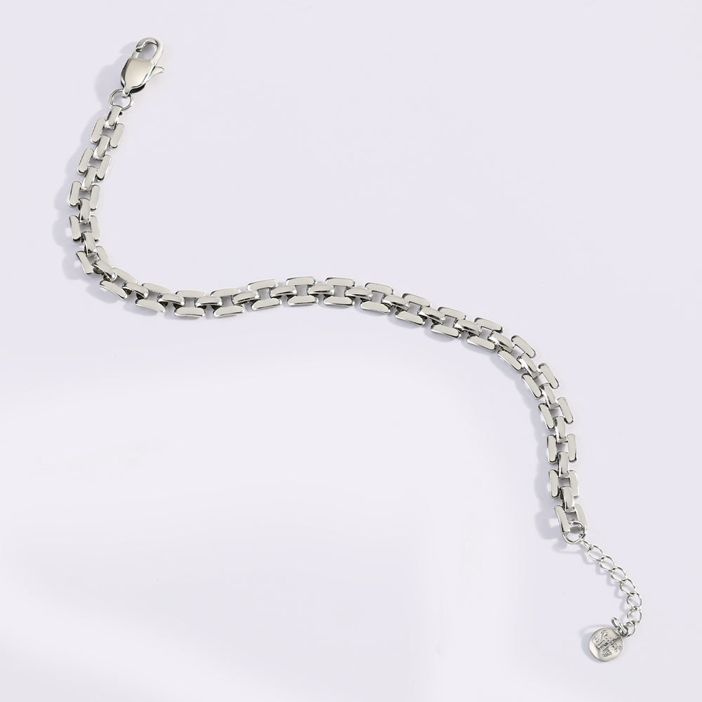Silver chain bracelet on a light gray background