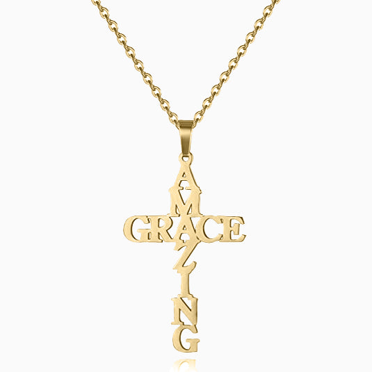 A gold-colored necklace with a cross pendant featuring the text 'Amazing Grace' and small crosses.